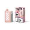 Rose-gold Vozol Vista 40000 peach berry disposable vape beside its pink packaging.